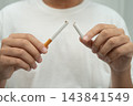 Man holding cigarette, no smoking. 143841549