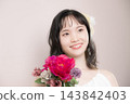[Pink background] Young Japanese woman in her 20s in a wedding dress, bride, wedding, bridal 143842403