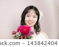 [Pink background] A young Japanese woman in her 20s in a wedding dress, looking at the camera, bride, wedding, bridal 143842404