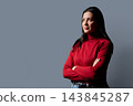 Profile portrait of beautiful confident 40 years old woman in red sweater on gray background 143845287