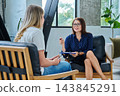 Middle aged professional female psychologist, counselor working with young woman 143845291