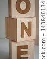 Minimalist 1st birthday studio setup with ONE wooden blocks and white cake stand 143846134