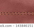 Professional double seam on brown suede leather garment close-up 143846151
