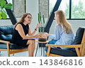 Professional female therapist counselor psychologist working with young woman patient 143846816