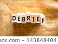 Debrief word symbol. Concept word Debrief on beautiful wooden blocks. Beautiful canvas background. Business debrief word concept. Copy space. 143848404