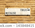 True or false symbol. Concept word True or False on beautiful white sign plate. Beautiful brick wall background. Business and true or false concept. Copy space. 143848415