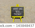 What do you think words symbol. Concept words What do you think on beautiful black blackboard. Beautiful sand beach background. Business What do you think motivational support concept. Copy space. 143848437