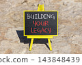 Building your legacy words symbol. Concept words Building your legacy on beautiful blackboard. Beautiful stone background. Business building your legacy concept. Copy space. 143848439