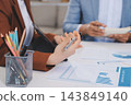 Business professional analyzing financial data on digital tablet dashboard with calculator and laptop, representing accounting software, ERP system integration, performance monitoring. 143849140