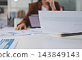 Business professional analyzing financial data on digital tablet dashboard with calculator and laptop, representing accounting software, ERP system integration, performance monitoring. 143849143
