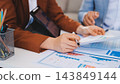 Business professional analyzing financial data on digital tablet dashboard with calculator and laptop, representing accounting software, ERP system integration, performance monitoring. 143849144