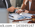 Businessmen or lawyers working together at a meeting, teamwork and partnership. Signing documents, contracts, checking details business agreement 143849147