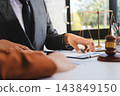 Businessmen or lawyers working together at a meeting, teamwork and partnership. Signing documents, contracts, checking details business agreement 143849150