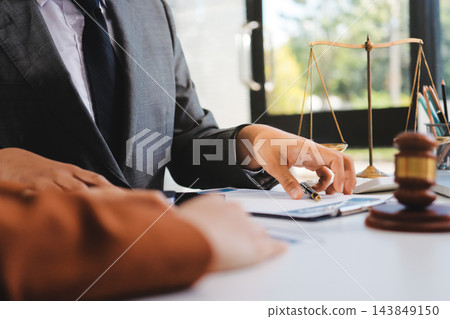 Businessmen or lawyers working together at a meeting, teamwork and partnership. Signing documents, contracts, checking details business agreement Businessmen or lawyers working together at a meeting, teamwork and partnership. Signing documents, contracts, checking details business agreement 143849150