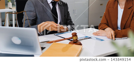 Businessmen or lawyers working together at a meeting, teamwork and partnership. Signing documents, contracts, checking details business agreement 143849154