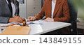 Businessmen or lawyers working together at a meeting, teamwork and partnership. Signing documents, contracts, checking details business agreement 143849155