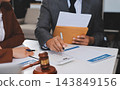 Businessmen or lawyers working together at a meeting, teamwork and partnership. Signing documents, contracts, checking details business agreement 143849156