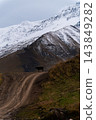 Silhouette of a cow on a dirt road in mountains 143849282