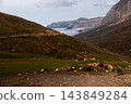 Mountain landscape with winding road and clouds in valley 143849284