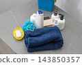 Towel washcloth, Bottles of shampoo, lotion liquid soap in the bathroom. Shower gel set for men 143850357