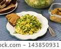 Quinoa, green peas, arugula, cauliflower, and broccoli sit with liver pate on a plate at a breakfast table, ready to eat in the morning 143850931