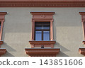 Historic building facade with classic decorative window frames 143851606