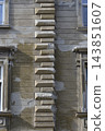 Old weathered historic building facade with rusticated corner quoins 143851607
