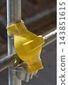 Yellow plastic protective cap on metal scaffolding joint 143851615