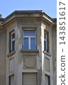 Old weathered historic building facade with bay window structure 143851617