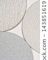 Three round abrasive sanding discs on grey background 143851619