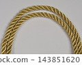 Gold twisted decorative cord on white background 143851620