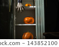 Pumpkins for Halloween stored in home green cabinet 143852100