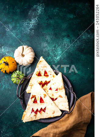 Spooky Halloween taco in shape of jack-o-lantern Spooky Halloween taco in shape of jack-o-lantern 143852264