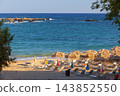 Straw Beach Umbrellas and Sun Loungers on Sandy Beach in Chania Crete Greece 143852550