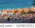 Straw Beach Umbrellas and Sun Loungers on Sandy Beach in Chania Crete Greece 143852551