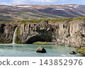 Turquoise Skjalfandafljot River Below Rocky Cliffs and a Small Side Cascade 143852976