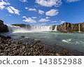 Godafoss waterfall and rocky river foreground from a low viewpoint in Iceland 143852988
