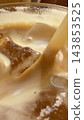 Close view of milk swirling around ice in a coffee drink 143853525