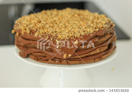 Homemade chocolate cake with nuts served on a plate close up Homemade chocolate cake with nuts served on a plate close up 143853688
