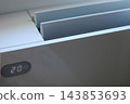 Air conditioner displaying twenty degrees on display 143853693