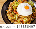 Fried noodles with fried egg 143856497
