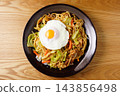 Fried noodles with fried egg 143856498