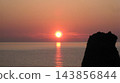 Strange rock formations alongside the setting sun over the sea 143856844