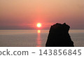 Strange rock formations alongside the setting sun over the sea 143856845