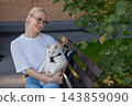 The owner puts the cat into a transparent carrier backpack. 143859090