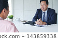 Businessman job interview by human resource HR officer interviwing, talk new employee shaking hands in office with smiling face. HR Manager interview check resume, face to face. Job Interview Concept 143859338