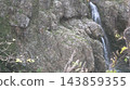 A small waterfall in a valley 143859355
