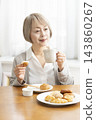 A senior woman's breakfast of freshly baked bread 143860267