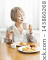 A senior woman's breakfast of freshly baked bread 143860268