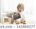 A senior woman's breakfast of freshly baked bread 143860277